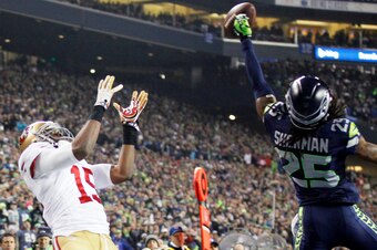 Jan 19, 2014; Seattle, WA, USA; Seattle Seahawks cornerback Richard Sherman (25) tips a pass intended for San Francisco 49ers wide receiver Michael Crabtree (15) that is intercepted by Seahawks outside linebacker Malcolm Smith (not pictured) in the fourth