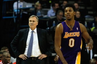 HOUSTON, TX - JANUARY 08:  Head coach Mike D'Antoni of the Los Angeles Lakers watches as Nick Young #0 runs on the court during the game against the Houston Rockets at the Toyota Center on January 8, 2014 in Houston, Texas. NOTE TO USER: User expressly ac