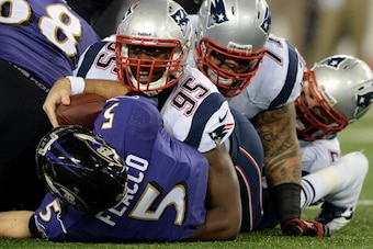 BALTIMORE, MD - DECEMBER 22: Defensive end Chandler Jones #95 of the New England Patriots and teammates tackle quarterback Joe Flacco #5 of the Baltimore Ravens in the first quarter at M&T Bank Stadium on December 22, 2013 in Baltimore, Maryland. (Photo b