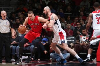 WASHINGTON, DC - JANUARY 3: Jonas Valanciunas #17 of the Toronto Raptors drives against Marcin Gortat #4 of the Washington Wizards during the game at the Verizon Center on January 3, 2014 in Washington, DC. NOTE TO USER: User expressly acknowledges and ag