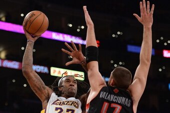 LOS ANGELES, CA - DECEMBER 08:  Jordan Hill #27 of the Los Angeles Lakers shoots over Jonas Valanciunas #17 of the Toronto Raptors at Staples Center on December 8, 2013 in Los Angeles, California.  NOTE TO USER: User expressly acknowledges and agrees that