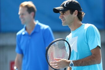 MELBOURNE, AUSTRALIA - JANUARY 23:  Roger Federer of Switzerland trains in a practice session as his coach, Stefan Edberg watches on during day 11 of the 2014 Australian Open at Melbourne Park on January 23, 2014 in Melbourne, Australia.  (Photo by Matt K