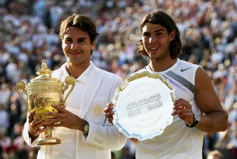 LONDON - JULY 08:  Roger Federer of Switzerland poses with the winners trophy alongside runner-up Rafael Nadal of Spain following the Men's Singles final match during day thirteen of the Wimbledon Lawn Tennis Championships at the All England Lawn Tennis a