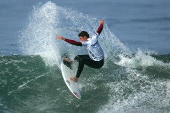 HUNTINGTON BEACH, CA - JULY 19:  Peter Mel (USA) slashes a turn on an inside wave in Heat 3 of the Round of 172 of the 2009 Hurley U.S. Open of Surfing on July 19, 2009 in Huntington Beach, California.  (Photo by Victor Decolongon/Getty Images)