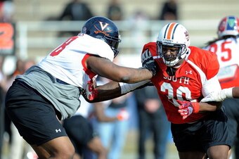 MOBILE, AL - JANUARY 20:  Dee Ford #30 of the South team works against Morgan Moses #78 during a Senior Bowl practice session at Fairhope Stadium on January 20, 2014 in Fairhope, Alabama.  (Photo by Stacy Revere/Getty Images)
