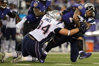 BALTIMORE, MD - DECEMBER 22: Running back Ray Rice #27 of the Baltimore Ravens is tackled by defensive tackle Chris Jones #94 of the New England Patriots in third quarter at M&T Bank Stadium on December 22, 2013 in Baltimore, Maryland. The New England Pat