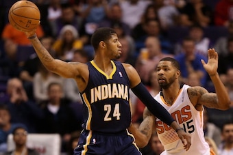 PHOENIX, AZ - JANUARY 22:  Paul George #24 of the Indiana Pacers looks to pass guarded by Marcus Morris #15 of the Phoenix Suns during the second half of the NBA game at US Airways Center on January 22, 2014 in Phoenix, Arizona.  The Suns defeated the Pac