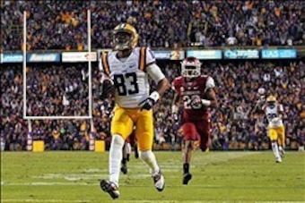 Nov 29, 2013; Baton Rouge, LA, USA; LSU Tigers wide receiver Travin Dural (83) carries the ball in front of Arkansas Razorbacks cornerback Jared Collins (29) for a touchdown in the fourth quarter at Tiger Stadium. LSU defeated Arkansas 31-27. Mandatory Cr