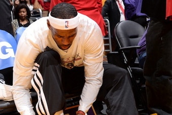 LOS ANGELES, CA - DECEMBER 25: LeBron James #6 of the Miami Heat ties his shoes before a game against the Los Angeles Lakers at STAPLES Center on December 25, 2013 in Los Angeles, California. NOTE TO USER: User expressly acknowledges and agrees that, by d