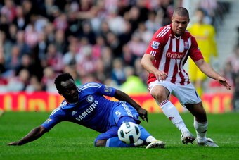 STOKE ON TRENT, ENGLAND - APRIL 02:  Michael Essien of Chelsea challenges Jonathan Walters of Stoke City during the Barclays Premier League match between Stoke City and Chelsea at the Britannia Stadium on April 2, 2011 in Stoke on Trent, England.  (Photo 