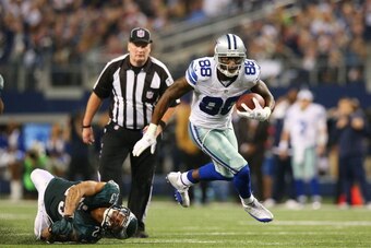 ARLINGTON, TX - DECEMBER 29:  Dez Bryant #88 of the Dallas Cowboys carries a pass for a fourth quarter touchdown against the defense of  Patrick Chung #23 of the Philadelphia Eagles at Cowboys Stadium on December 29, 2013 in Arlington, Texas.  (Photo by R