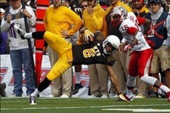 Oct 12, 2013; Laramie, WY, USA; Laramie, WY, USA; Wyoming Cowboys wide receiver Robert Herron (6) makes a reception against New Mexico Lobos cornerback SaQwan Edwards (15) during the first quarter at War Memorial Stadium. Mandatory Credit: Troy Babbitt-US