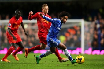 LONDON, ENGLAND - DECEMBER 29:  Willian of Chelsea holds off the challenge from Lucas Leiva of Liverpool during the Barclays Premier League match between Chelsea and Liverpool at Stamford Bridge on December 29, 2013 in London, England.  (Photo by Clive Ro