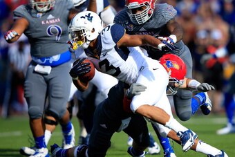 LAWRENCE, KS - NOVEMBER 16:  Running back Charles Sims #3 of the West Virginia Mountaineers carries the ball during the game against the Kansas Jayhawks at Memorial Stadium on November 16, 2013 in Lawrence, Kansas.  (Photo by Jamie Squire/Getty Images)