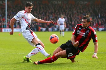 BOURNEMOUTH, ENGLAND - JANUARY 25:  Charlie Daniels of Bournemouth attempts to block the cross of Martin Kelly of Liverpool during the FA Cup Fourth Round match between Bournemouth and Liverpool at Goldsands Stadium on January 25, 2014 in Bournemouth, Eng