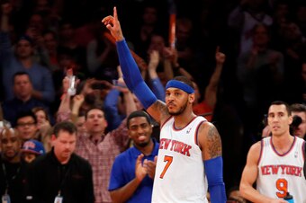 Jan 24, 2014; New York, NY, USA;  New York Knicks small forward Carmelo Anthony (7) reacts and waves to the crowd after scoring 62 points in the game against the Charlotte Bobcats at Madison Square Garden. Mandatory Credit: Noah K. Murray-USA TODAY Sports