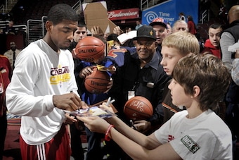 CLEVELAND, OH - MARCH 25:  Kyrie Irving #2 of the Cleveland Cavaliers signs his autograph for fans prior to the game against the Phoenix Suns at The Quicken Loans Arena on March 25, 2012 in Cleveland, Ohio. NOTE TO USER: User expressly acknowledges and ag