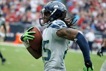 HOUSTON, TX - SEPTEMBER 29:  Richard Sherman #25 of the Seattle Seahawks  returns an interception 58 yaerds for a touchdown in the second half against the Houston Texans at Reliant Stadium on September 29, 2013 in Houston, Texas.  (Photo by Scott Halleran