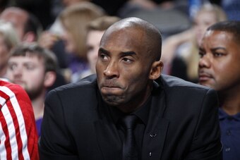 DALLAS, TX - JANUARY 7: Kobe Bryant #24 of the Los Angeles Lakers watches his team from the bench against the Dallas Mavericks on January 7, 2014 at the American Airlines Center in Dallas, Texas. NOTE TO USER: User expressly acknowledges and agrees that, 