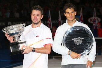 MELBOURNE, AUSTRALIA - JANUARY 26:  Stanislas Wawrinka of Switzerland holds the Norman Brookes Challenge Cup after winning, and Rafael Nadal of Spain holds the runner up plate after their men's final match during day 14 of the 2014 Australian Open at Melb