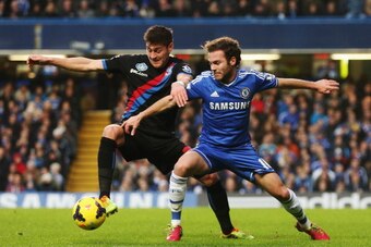 LONDON, ENGLAND - DECEMBER 14:  (L-R) Joel Ward of Crystal Palace and Juan Mata of Chelsea challenge for the ball during the Barclays Premier League match between Chelsea and Crystal Palace at Stamford Bridge on December 14, 2013 in London, England.  (Pho