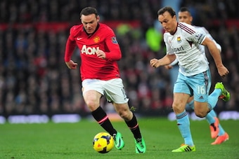 MANCHESTER, ENGLAND - DECEMBER 21:  Wayne Rooney of Manchester United competes with Mark Noble of West Ham United during the Barclays Premier League match between Manchester United and West Ham United at Old Trafford on December 21, 2013 in Manchester, En