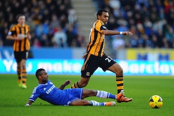 HULL, ENGLAND - JANUARY 11:  Ashley Cole of Chelsea tackles Ahmed Elmohamady of Hull City during the Barclays Premier League match between Hull City and Chelsea at KC Stadium on January 11, 2014 in Hull, England.  (Photo by Laurence Griffiths/Getty Images