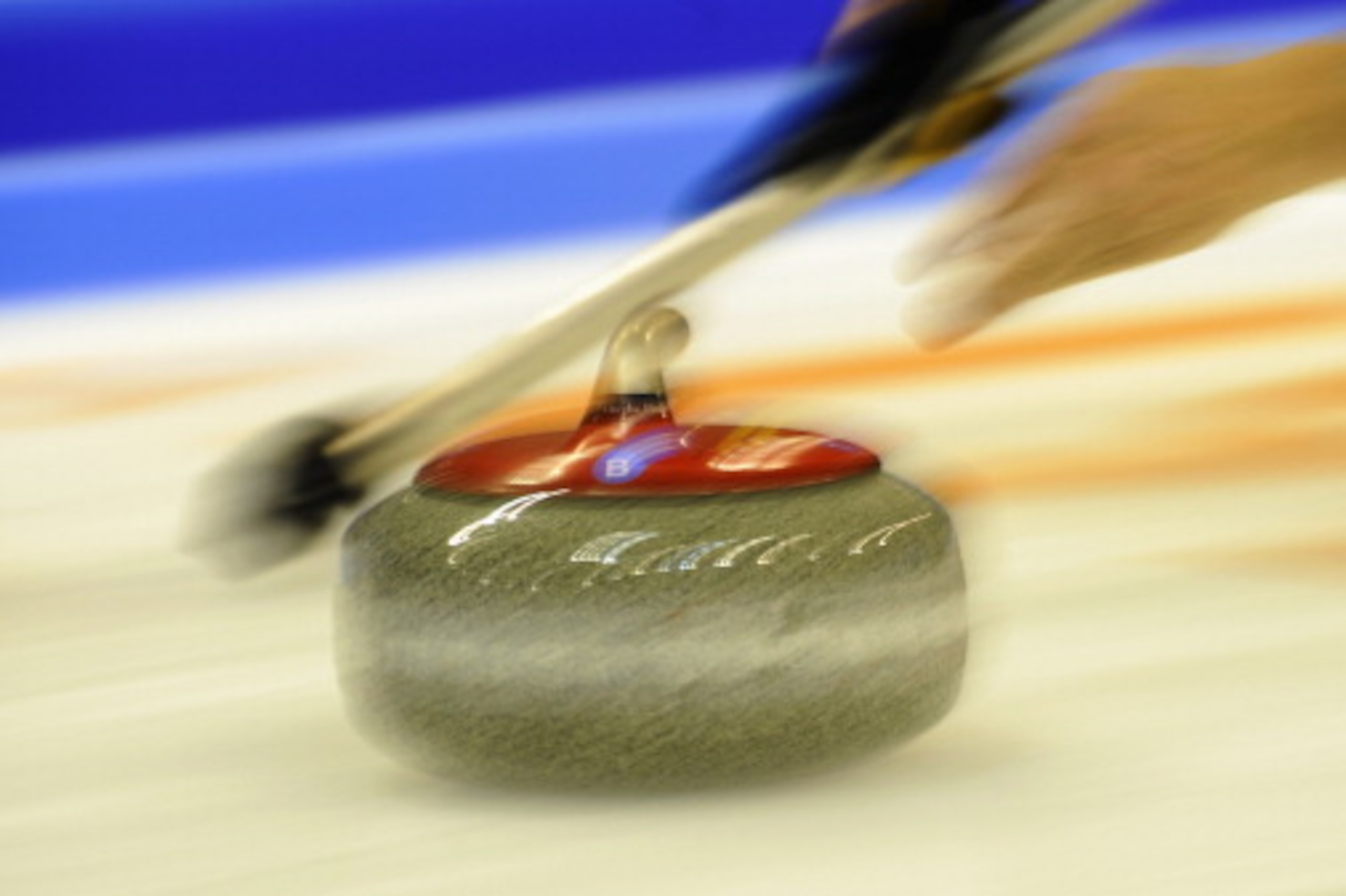 FUSSEN, GERMANY - DECEMBER 10:  A player throws a rock during the Olympic Qualification Tournament on December 10, 2013 in Fussen, Germany.  (Photo by Daniel Kopatsch/Getty Images,)