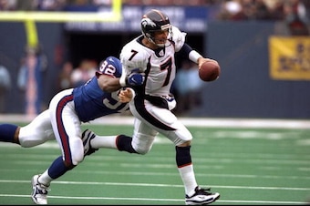 13 Dec 1998: Quarterback John Elway #7 of the Denver Broncos in action against defensive end Michael Strahan #92 of the New York Giants during the game at Giants Stadium in East Rutherford, New Jersey. The Giants defeated the Broncos 21-16.
