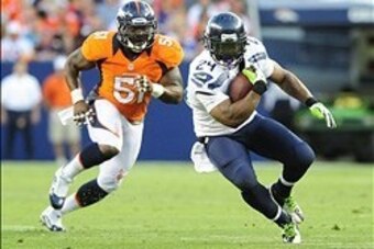 Aug 18, 2012; Denver, CO, USA;  Seattle Seahawks running back Marshawn Lynch (24) is pursued by Denver Broncos linebacker Joe Mays (51) in the first  quarter at Sports Authority Field.  Mandatory Credit: Byron Hetzler-USA TODAY Sports