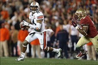 Jan 6, 2014; Pasadena, CA, USA; Auburn Tigers quarterback Nick Marshall (14) looks to throw as he is chased by Florida State Seminoles linebacker Christian Jones (7) during the first half of the 2014 BCS National Championship game at the Rose Bowl.  Manda