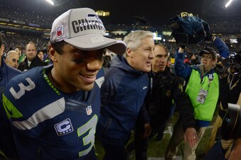 Jan 19, 2014; Seattle, WA, USA; Seattle Seahawks quarterback Russell Wilson (3) leaves the field with head coach Pete Carroll (right) after the 2013 NFC Championship football game against the San Francisco 49ers at CenturyLink Field. Mandatory Credit: Kir