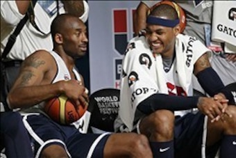 July 14, 2012; Washington, DC, USA; United States forward Kobe Bryant (10) and United States forward Carmelo Anthony (15) smile on the sidelines during USA team training at the DC Armory. Mandatory Credit: Geoff Burke-USA TODAY Sports