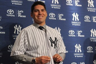 NEW YORK, NY - DECEMBER 13: Centerfielder Jacoby Ellsbury puts on his jersey during his introductory press conference at Yankee Stadium on December 13, 2013 in the Bronx borough of New York City.  (Photo by Maddie Meyer/Getty Images)