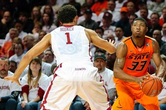 Jan 27, 2014; Norman, OK, USA; Oklahoma State Cowboys guard Marcus Smart (33) shoots as Oklahoma Sooners guard Frank Booker (1) defends during the game at Lloyd Noble Center. Oklahoma won 88-76. Mandatory Credit: Kevin Jairaj-USA TODAY Sports