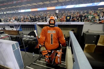LOS ANGELES-JANUARY 25: (EDITORIAL USE ONLY) Goalkeeper Jonas Hiller #1 of the Anaheim Ducks steps down into the visitors dugout as he leaves the baseball diamond after shutting out Los Angeles Kings during the 2014 Coors Light Stadium Series at Dodger St