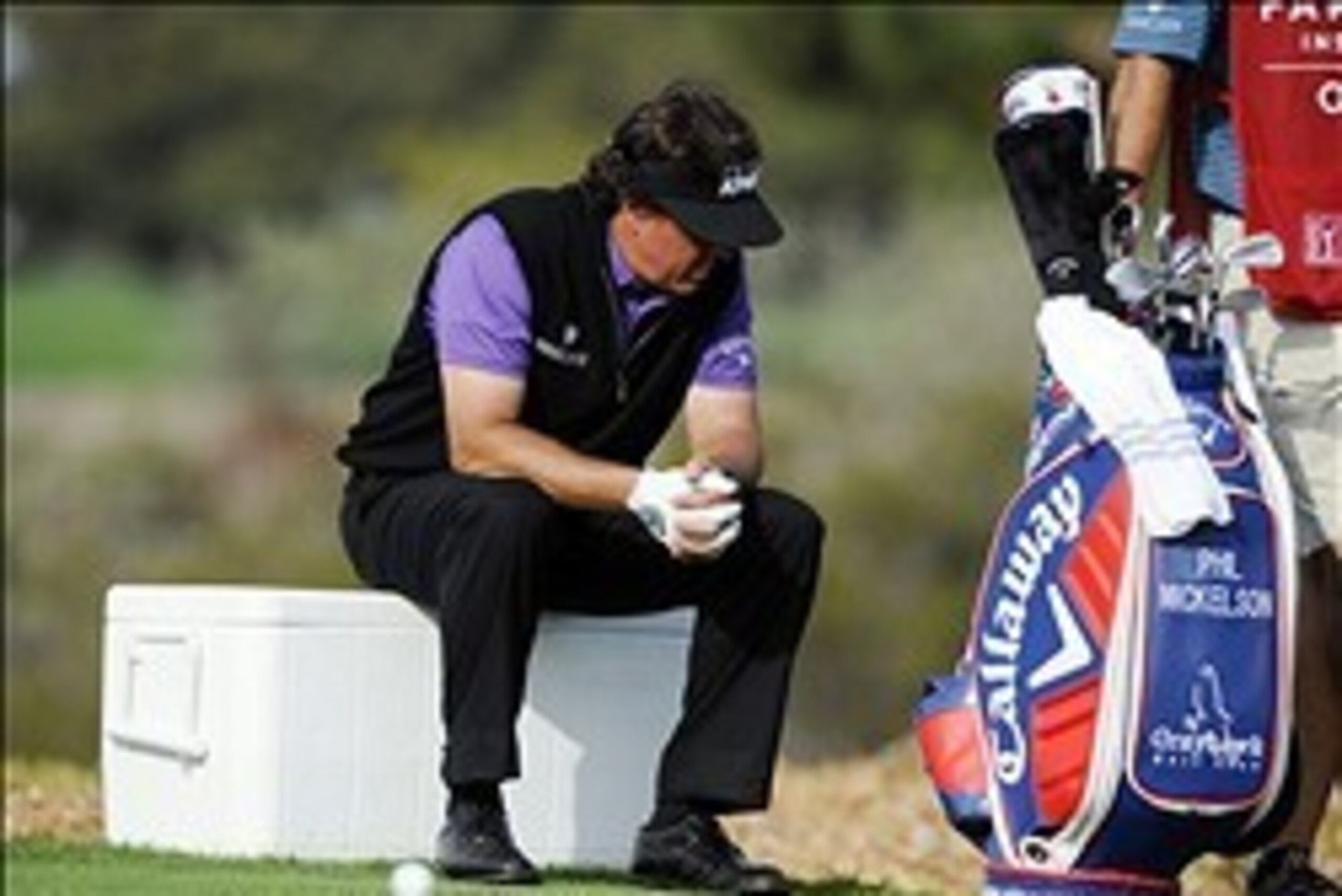 Jan 23, 2014; La Jolla, CA, USA; Phil Mickelson rests on an ice chest after his tee shot from the ninth hole during the first round of the Farmers Insurance Open golf tournament at Torrey Pines Municipal Golf Course. Mandatory Credit: Christopher Hanewinc