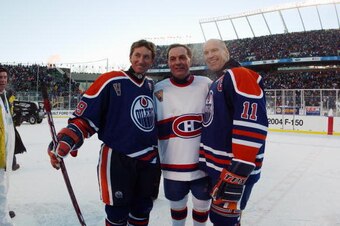 EDMONTON, CANADA - NOVEMBER 22:  Wayne Gretzky #99 of the Edmonton Oilers and teammate Mark Messier #11 pose for a photo with Guy Lafleur #10 of the Montreal Canadiens during the Molson Canadien Heritage Classic on November 22, 2003 at Commonwealth Stadiu