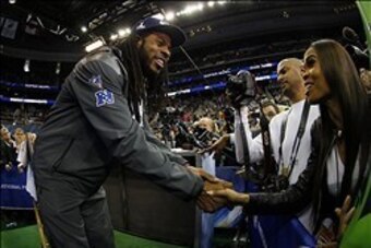 Jan 28, 2014; Newark, NJ, USA; Seattle Seahawks cornerback Richard Sherman (25) speaks to recording artist Michelle Williams (right) the media during Media Day for Super Bowl XLVIII at Prudential Center. Mandatory Credit: Adam Hunger-USA TODAY Sports