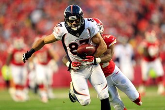 KANSAS CITY, MO - DECEMBER 01:  Wide receiver Eric Decker #87 of the Denver Broncos makes a catch as cornerback Marcus Cooper #31 of the Kansas City Chiefs defends during the game at Arrowhead Stadium on December 1, 2013 in Kansas City, Missouri.  (Photo 