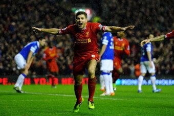 LIVERPOOL, ENGLAND - JANUARY 28:  Steven Gerrard of Liverpool celebrates after scoring the opening goal during the Barclays Premier League match between Liverpool and Everton at Anfield on January 28, 2014 in Liverpool, England.  (Photo by Laurence Griffi