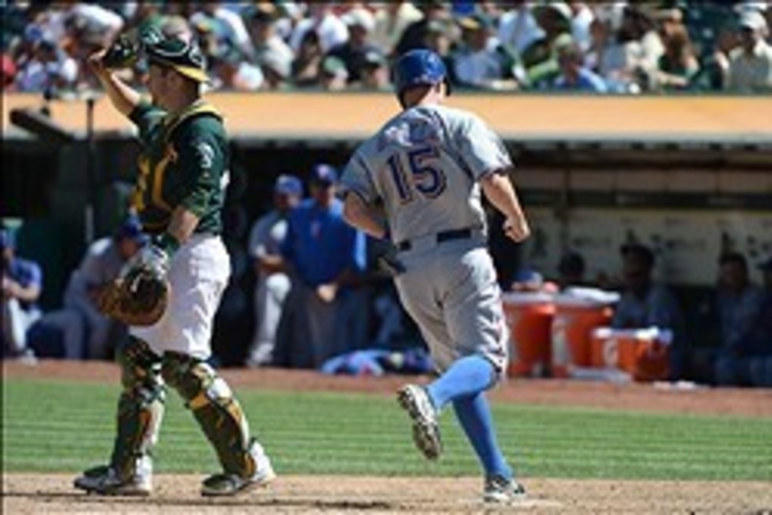 September 4, 2013; Oakland, CA, USA; Texas Rangers runner Jeff Baker (15) scores on a RBI-single by pinch hitter Joey Butler (20, not pictured) against Oakland Athletics catcher Stephen Vogt (21, left) during the seventh inning at O.co Coliseum. Mandatory