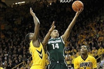 Jan 28, 2014; Iowa City, IA, USA; Iowa Hawkeyes forward Gabriel Olaseni (0) defends Michigan State Spartans guard Gary Harris (14) during the first half at Carver-Hawkeye Arena. Mandatory Credit: Reese Strickland-USA TODAY Sports