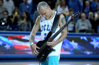 LOS ANGELES, CA - JANUARY 09:  Bassist Flea of the Red Hot Chili Peppers performs the national anthem before the game between the Arizona Wildcats and the UCLA Bruins at Pauley Pavilion on January 9, 2014 in Los Angeles, California.  (Photo by Stephen Dun