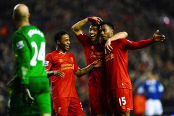 LIVERPOOL, ENGLAND - JANUARY 28:  Daniel Sturridge (R) of Liverpool is congratulated by teammates Luis Suarez (C) and Raheem Sterling (L) after scoring his team's third goal as dejected Everton goalkeeper Tim Howard looks on during the Barclays Premier Le