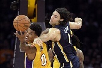 Jan 28, 2014; Los Angeles, CA, USA; Indiana Pacers power forward Luis Scola (4) defends against Los Angeles Lakers small forward Nick Young (0)  during the first half at Staples Center. Mandatory Credit: Richard Mackson-USA TODAY Sports