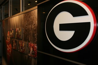 Images of former Georgia stars line the hallway of the coaches offices
