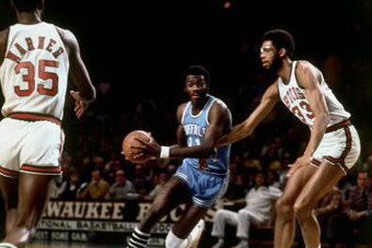 MILWAUKEE - 1975:  Bob McAdoo #11 of the of the Buffalo Braves drives to the basket against Kareem Abdul-Jabbar #33 of the Milwaukee Bucks during the 1975 season at the MECCA Arena in Milwaukee, Wisconsin. NOTE TO USER: User expressly acknowledges that, b