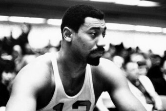 PHILADELPHIA - 1960:  Wilt Chamberlain #13 of the Philadelphia Warriors catches his breath from the bench during an NBA game circa 1960 in Philadelphia, Pennsylvania.  NOTE TO USER: User expressly acknowledges that, by downloading and or using this photog