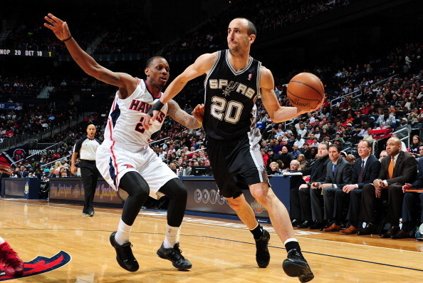 ATLANTA, GA - JANUARY 24: Manu Ginobili #20 of the San Antonio Spurs handles the ball against the Atlanta Hawks on January 24, 2014 at Philips Arena in Atlanta, Georgia.  NOTE TO USER: User expressly acknowledges and agrees that, by downloading and/or usi